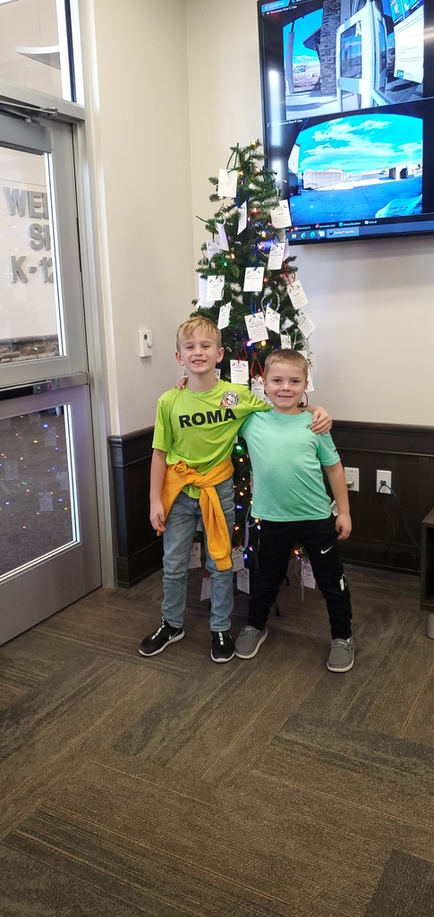 2nd Graders putting up Giving Tree