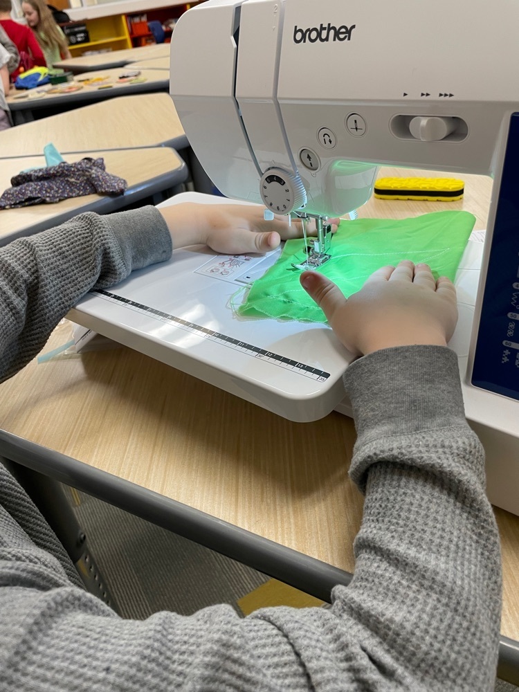 Student using sewing machine.