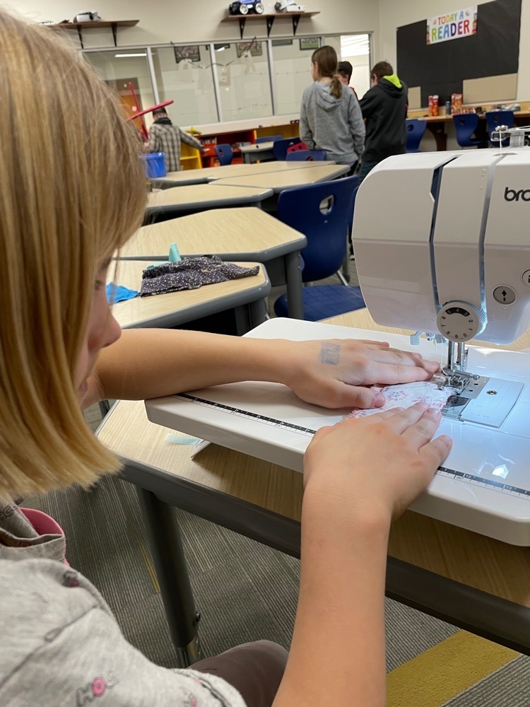 Student using sewing machine.
